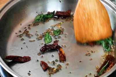 Tempering the spices for cabbage thoran